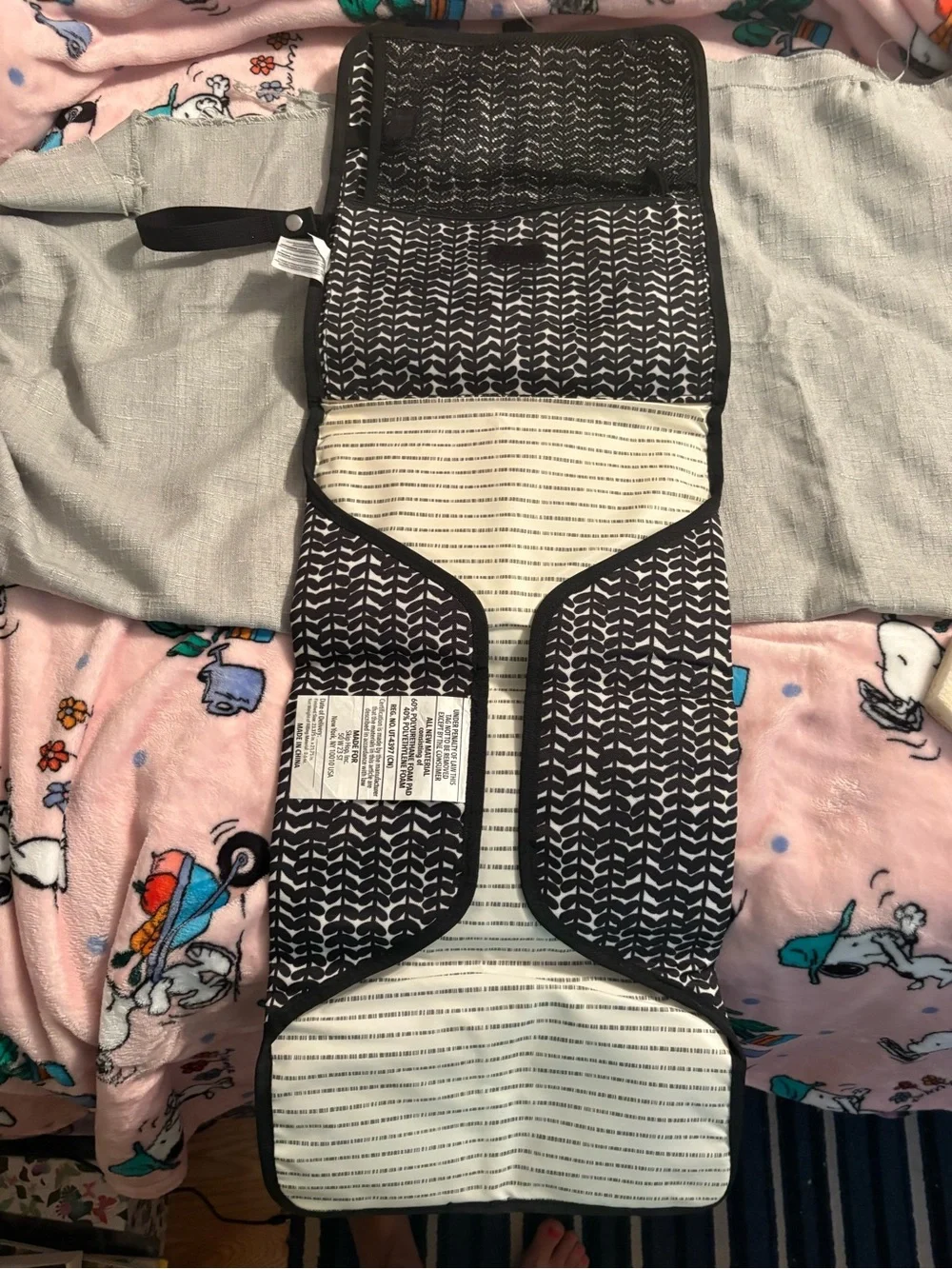 Skidaddle by Skip Hop Black & White Travel diaper bag with fold out changing pad